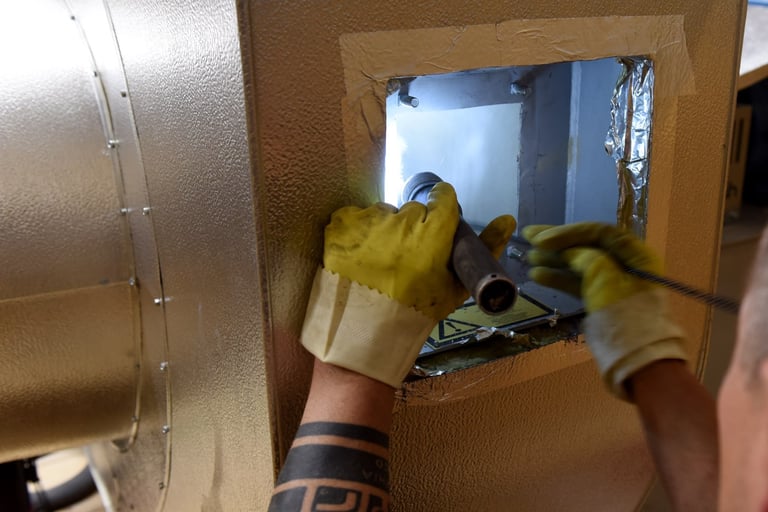 Arbeiter mit gelben Handschuhen greift in Werkzeugkiste während Installationsarbeiten